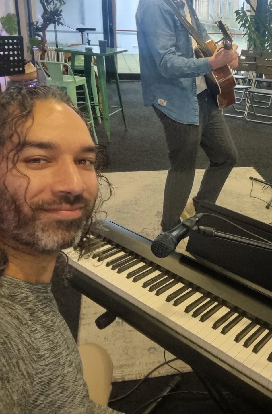 Delano Keuter at the piano with another musician in church.